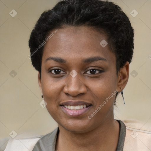 Joyful black young-adult female with short  black hair and brown eyes