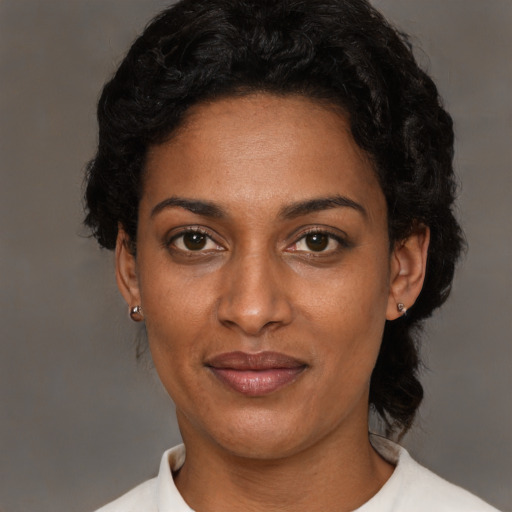 Joyful latino adult female with short  black hair and brown eyes