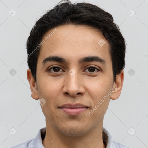 Joyful latino young-adult male with short  black hair and brown eyes