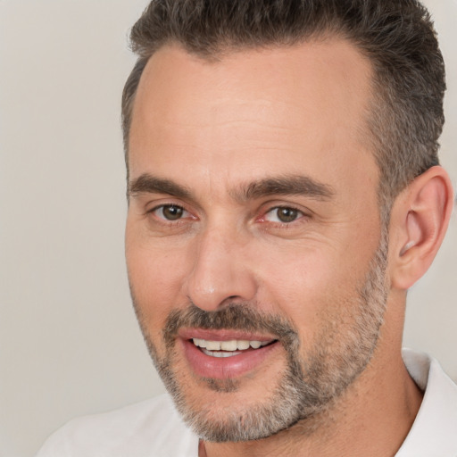 Joyful white adult male with short  brown hair and brown eyes