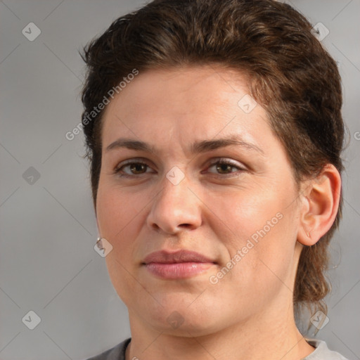 Joyful white adult female with medium  brown hair and brown eyes