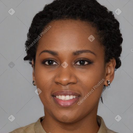 Joyful black young-adult female with short  black hair and brown eyes