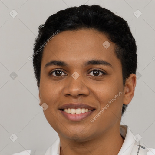 Joyful latino young-adult female with short  black hair and brown eyes