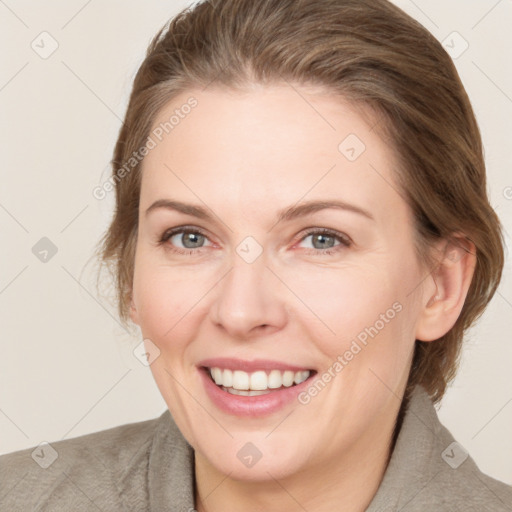 Joyful white adult female with medium  brown hair and grey eyes