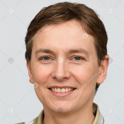 Joyful white adult female with short  brown hair and grey eyes