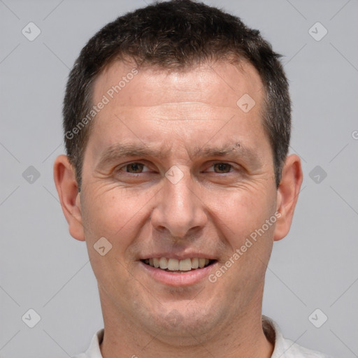 Joyful white adult male with short  brown hair and brown eyes