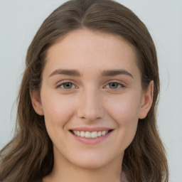 Joyful white young-adult female with long  brown hair and green eyes