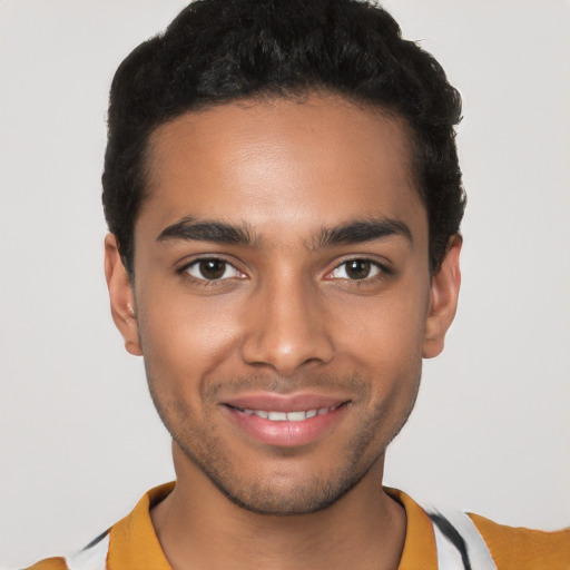 Joyful latino young-adult male with short  black hair and brown eyes