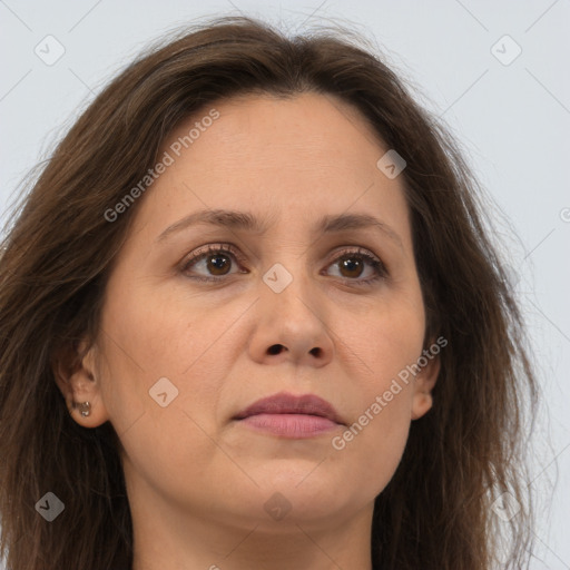 Joyful white adult female with long  brown hair and brown eyes