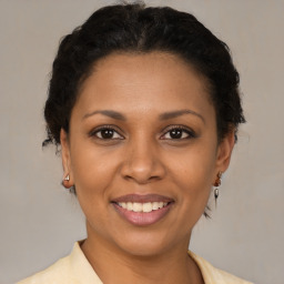 Joyful latino young-adult female with short  brown hair and brown eyes