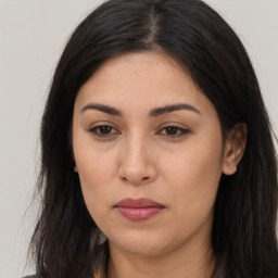 Joyful latino young-adult female with long  brown hair and brown eyes