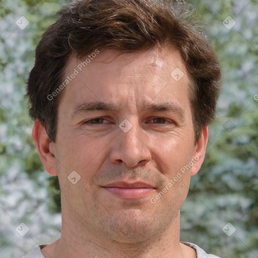 Joyful white adult male with short  brown hair and grey eyes