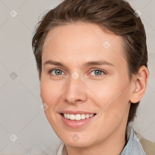 Joyful white young-adult female with medium  brown hair and grey eyes