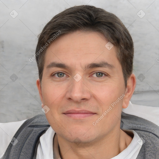 Joyful white adult male with short  brown hair and brown eyes