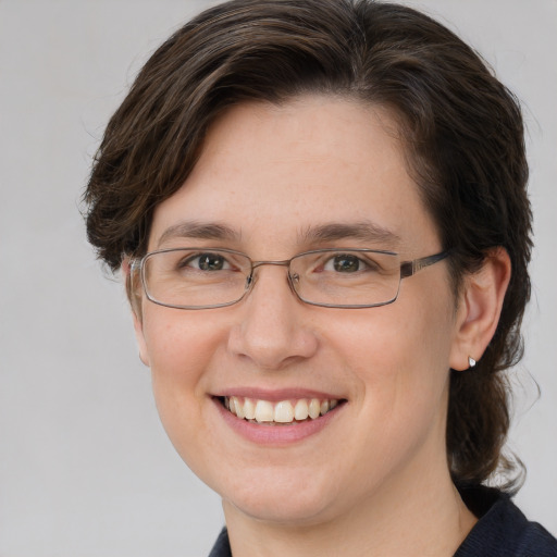 Joyful white adult female with medium  brown hair and grey eyes