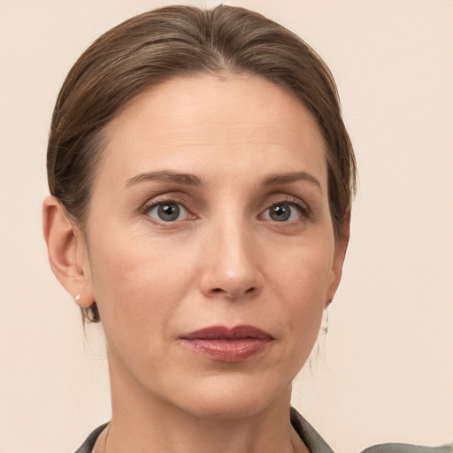 Joyful white adult female with medium  brown hair and grey eyes