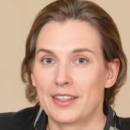 Joyful white adult female with medium  brown hair and grey eyes