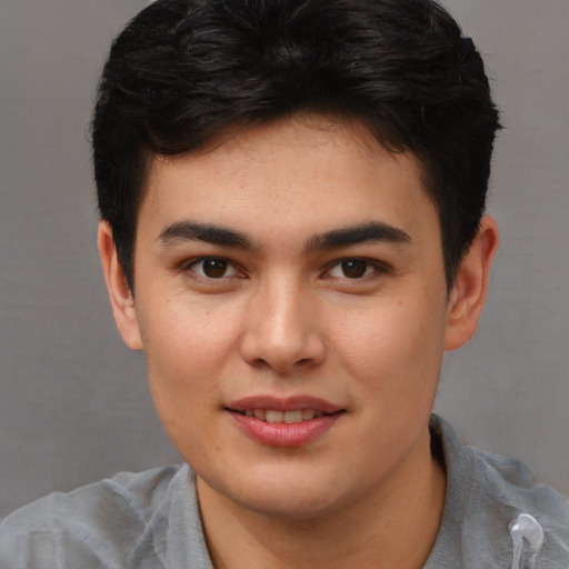 Joyful asian young-adult male with short  brown hair and brown eyes
