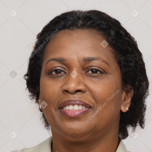 Joyful black adult female with medium  brown hair and brown eyes