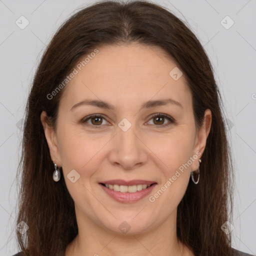 Joyful white adult female with long  brown hair and brown eyes