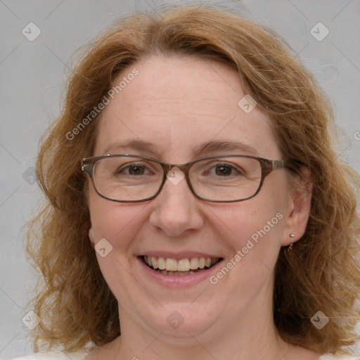 Joyful white adult female with medium  brown hair and blue eyes