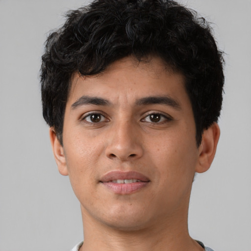Joyful latino young-adult male with short  brown hair and brown eyes