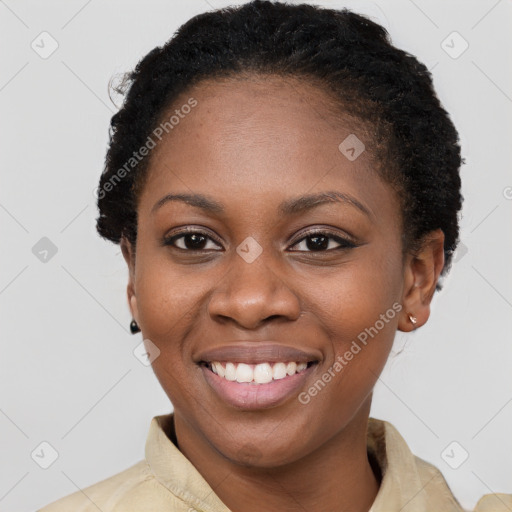 Joyful black young-adult female with short  black hair and brown eyes