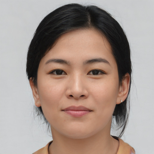 Joyful asian young-adult female with medium  brown hair and brown eyes