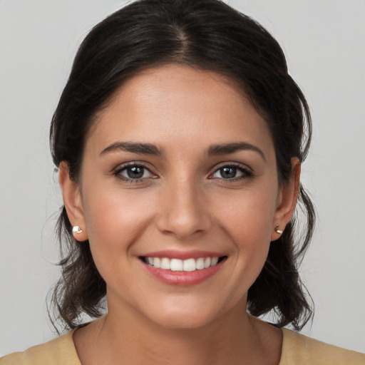 Joyful white young-adult female with medium  brown hair and brown eyes