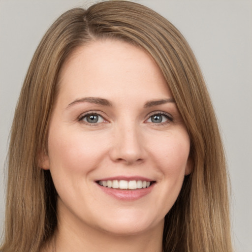 Joyful white young-adult female with long  brown hair and brown eyes