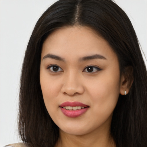 Joyful asian young-adult female with long  brown hair and brown eyes