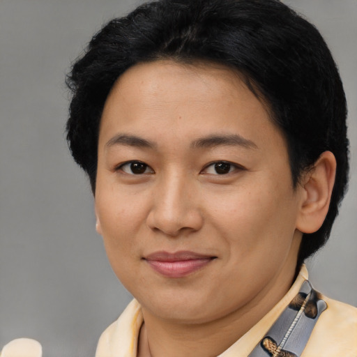Joyful latino adult female with short  brown hair and brown eyes