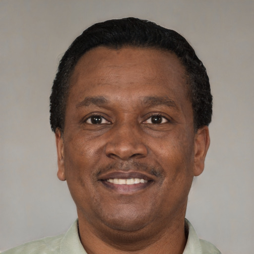 Joyful black adult male with short  black hair and brown eyes