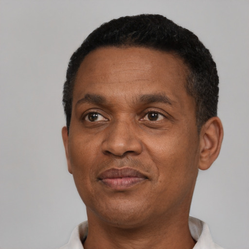 Joyful black adult male with short  black hair and brown eyes