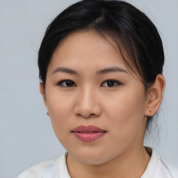 Joyful asian young-adult female with medium  brown hair and brown eyes