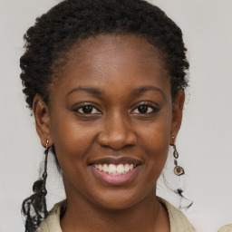 Joyful black young-adult female with medium  brown hair and brown eyes