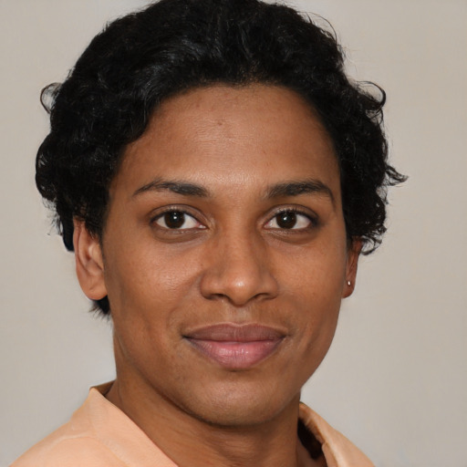 Joyful black young-adult female with short  brown hair and brown eyes