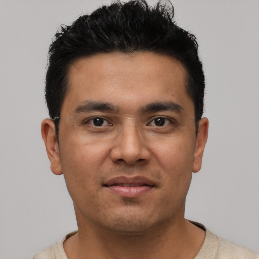Joyful asian young-adult male with short  black hair and brown eyes