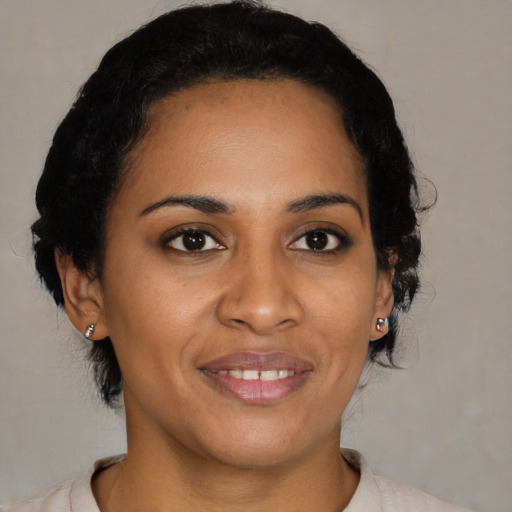 Joyful black young-adult female with medium  brown hair and brown eyes