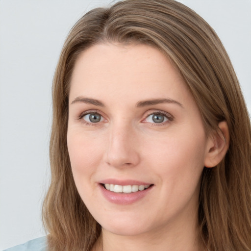 Joyful white young-adult female with long  brown hair and grey eyes