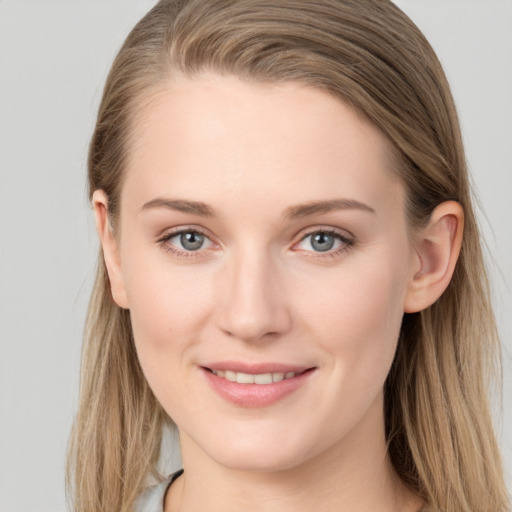 Joyful white young-adult female with long  brown hair and grey eyes