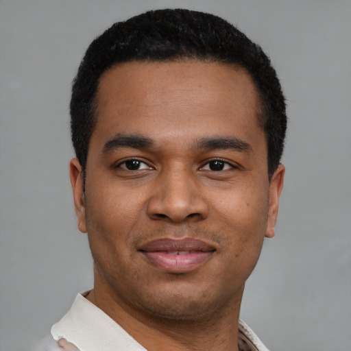 Joyful latino young-adult male with short  black hair and brown eyes