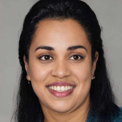 Joyful latino young-adult female with long  black hair and brown eyes