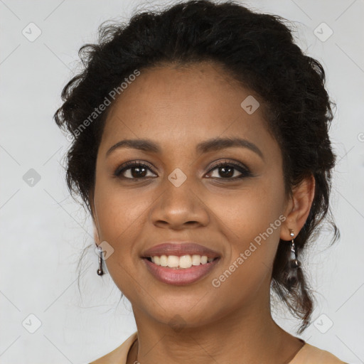 Joyful black young-adult female with long  brown hair and brown eyes