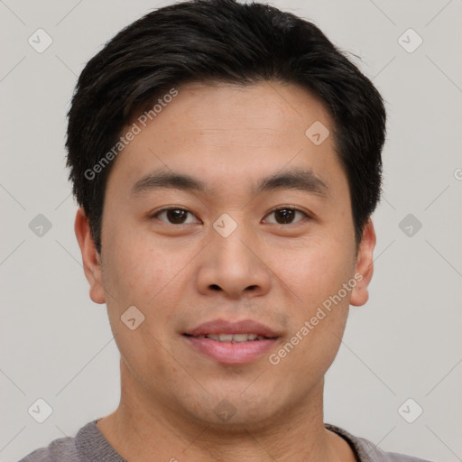 Joyful asian young-adult male with short  brown hair and brown eyes