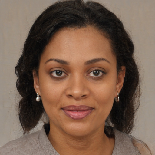 Joyful black young-adult female with medium  brown hair and brown eyes