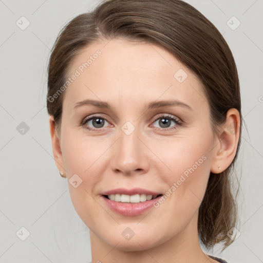 Joyful white young-adult female with medium  brown hair and grey eyes