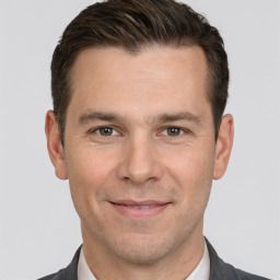 Joyful white adult male with short  brown hair and brown eyes