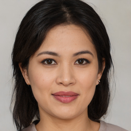 Joyful asian young-adult female with medium  brown hair and brown eyes