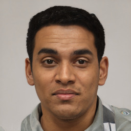 Joyful latino young-adult male with short  black hair and brown eyes